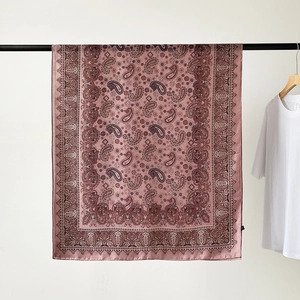 Detail of a silky cotton-linen scarf with vintage Paisley patterns in dusty rose