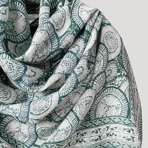 Close-up of green mandala pattern on vintage cream linen scarf showing fabric texture