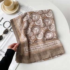 Elegant silk scarf with shell floral pattern styled with sunglasses and coffee on white table