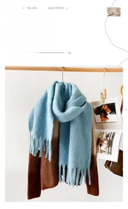 Close-up of thick mohair scarf showing soft brushed texture and heavy chunky tassels
