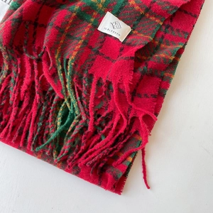 Classic red and green plaid bouclé scarf with elegant fringe and weave texture