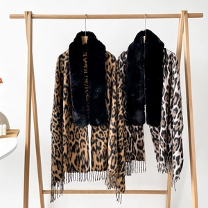 Detail of leopard print shawls with luxury faux fur collars and tassel hem decorations