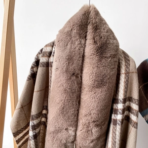 Detail of soft faux fox fur collar on a brown plaid winter shawl wrap for women