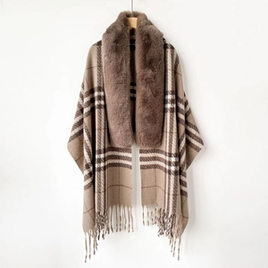 Detailed view of plaid shawl cape featuring fluffy faux fur collar and fringed hem design