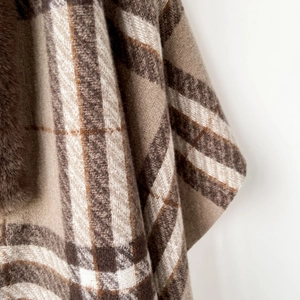 Close-up of classic beige plaid shawl featuring high-quality faux fur collar trim