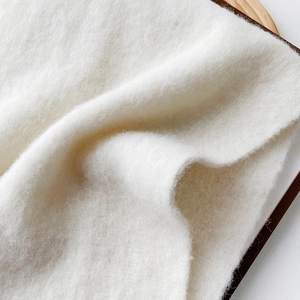 Macro close-up of soft white mohair wool scarf showing detailed fluffy texture and fibers