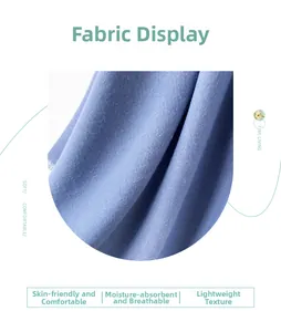 Close-up of blue cotton linen scarf fabric showing fine twill texture and tassel fringe