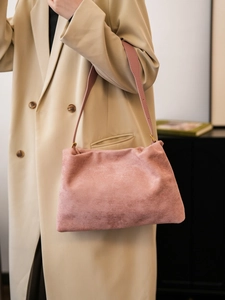 Detailed close-up of a pink suede Boston shoulder bag with soft textured leather finish