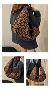 Macro detail of leopard print tote bag fabric and metal magnetic closure showing rich texture