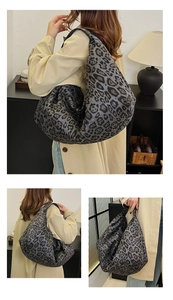 Detailed macro view of high-capacity faux suede hobo bag with dark leopard print pattern