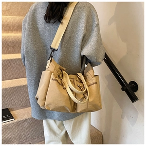 Khaki canvas multi-pocket tote bag with shoulder strap shown in a lifestyle scene