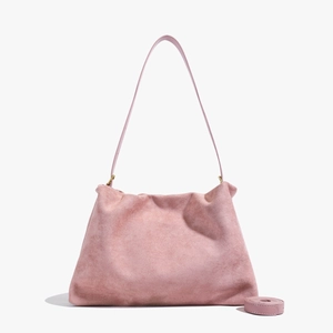 Detail view of pink suede Boston bag with soft texture and vintage gold metal hardware