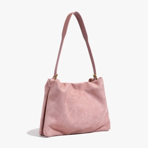 Detail of pink suede boston bag showing premium matte texture and gold metal buckle