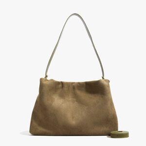Detail of brown suede Boston bag showing soft texture and extra adjustable long strap