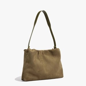 Side view of khaki suede Boston bag featuring olive green leather shoulder straps