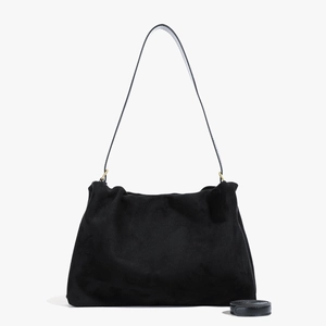 Detail view of black suede Boston bag showing soft texture and dual strap attachment