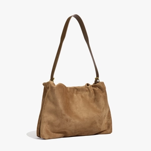 Close-up of brown suede Boston bag showing soft vintage matte leather texture and strap