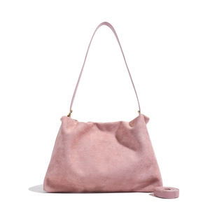 Detailed macro view of pink suede boston bag with soft texture and leather shoulder strap