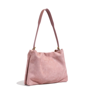 Close-up of pink suede Boston bag featuring soft texture and golden metal adjustment buckle