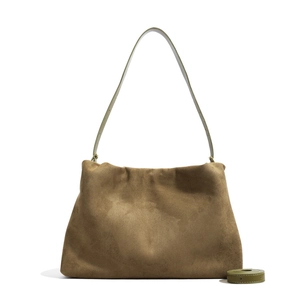 Detail of dark brown suede Boston bag featuring contrasting green leather shoulder strap