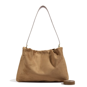 Detail showing soft suede texture and adjustable strap of this caramel Boston bag