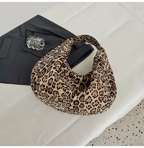 Macro shot of faux suede leopard print texture on a large capacity hobo tote bag