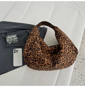 Detail view of large leopard print hobo tote bag featuring soft texture and wide shoulder strap
