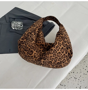 Close-up of leopard print tote bag showing soft plush texture on white background
