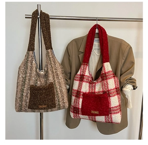 Close-up of plush plaid tote bags with fuzzy handles and small leather brand tags
