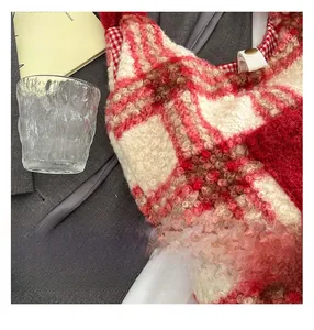 Detail view of the plush red plaid tote bag featuring high-quality metal buckles and stitching