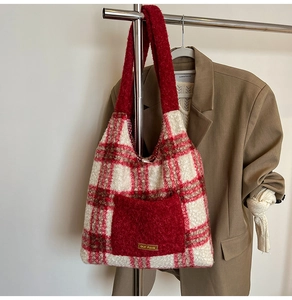 Detail of red and white checkered plush tote bag with a front pocket and warm fuzzy texture