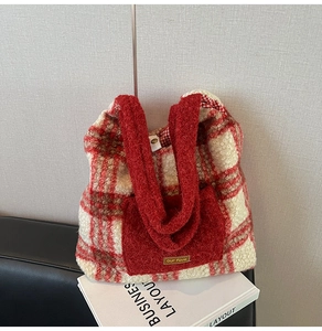 Detail of red and white checkered plush tote bag with cozy fleece texture and front pocket