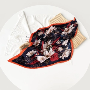 Navy blue pleated floral silk scarf with vibrant orange edges and blooming flower print