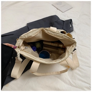 Interior view of beige nylon tote bag showing large capacity for cosmetics and skincare