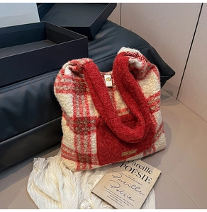 Close-up of plush red plaid tote bag featuring fuzzy lamb wool texture and front pocket detail
