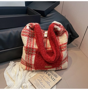 Close-up of red plaid plush tote bag with furry texture and metal buckle detail