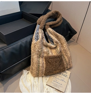 Detail of plush tote bag with beige brown stripes and soft fuzzy texture on front pocket