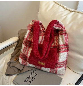 Detail of red and white plaid plush tote bag with fuzzy handles and brand tag