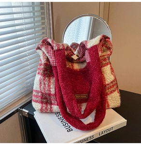 Detail of red and white checkered plush tote bag showing soft wool texture and snap button