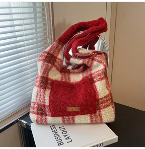 Detail view of red plaid plush tote bag with furry texture and metal ring handles