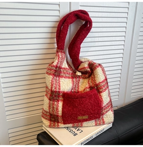 Detail of red and white checkered plush tote bag with lamb wool texture and front pocket