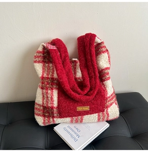 Close-up of red and white checkered plush tote bag with furry texture and pocket