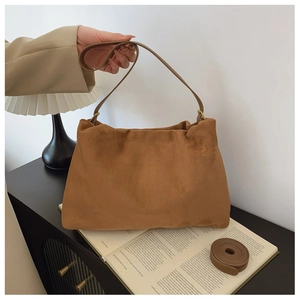 Brown suede Boston bag detail showing the texture and detachable shoulder straps