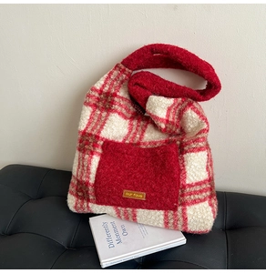 Detail shot of the plush red and white checkered tote bag with lamb wool texture