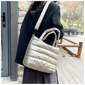 Champagne gold quilted puffer tote bag with thick handles and adjustable strap