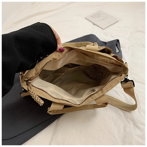 Internal view of a large khaki tote bag showing spacious compartments and a zipper pocket