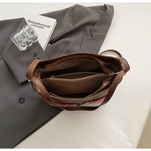 Vue intérieure du sac cabas en cuir marron avec trois compartiments et doublure rayée