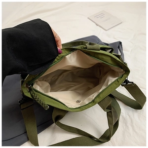 Internal view of army green nylon tote bag showing spacious capacity and beige fabric lining