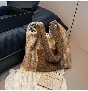 Detail of plush tote bag featuring contrast colors, checkered lining, and weaved label