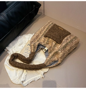 Detailed close-up of plush plaid tote bag with brown fur pocket and magnetic metal snap button